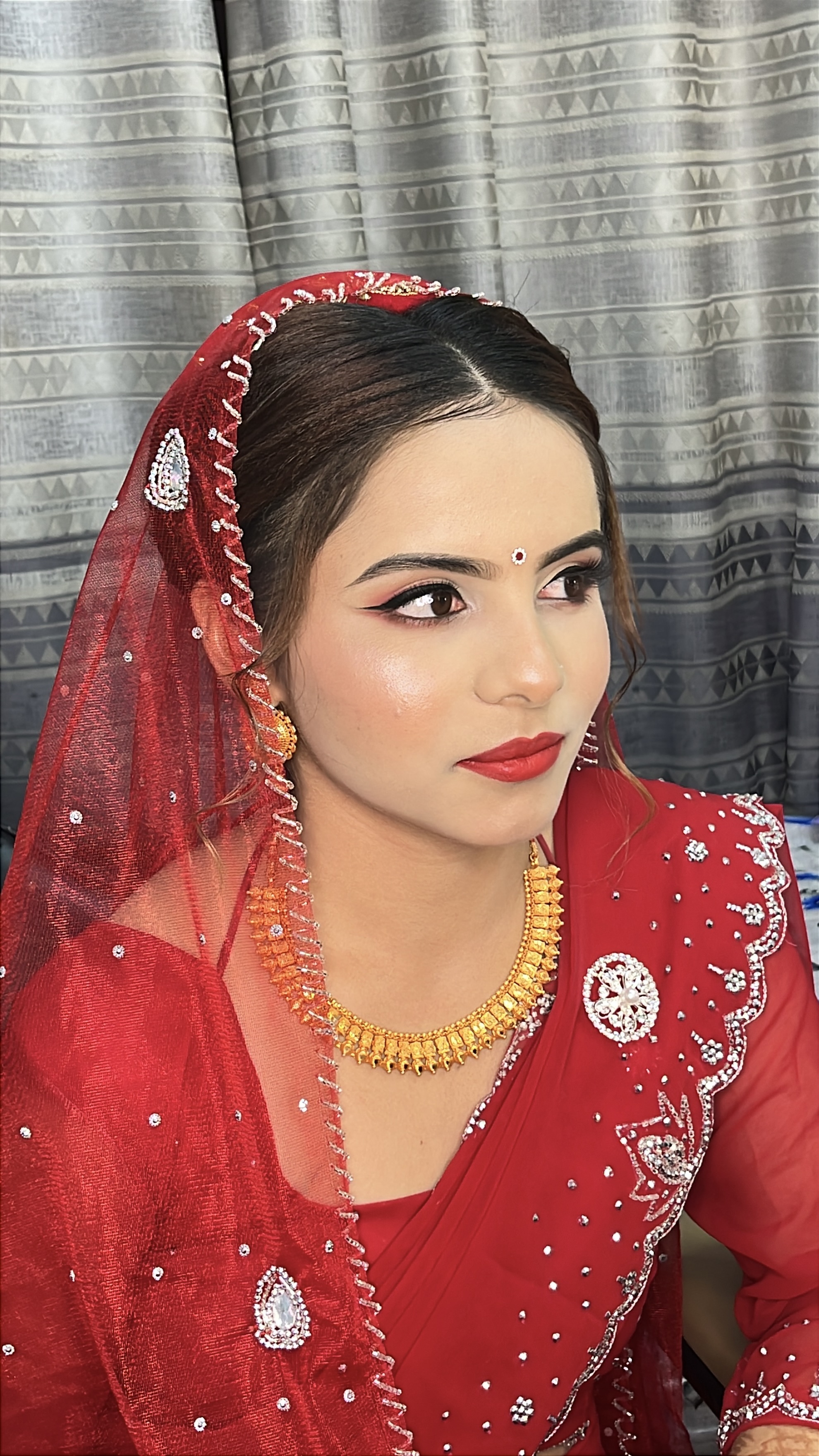 A bride receiving professional makeup application