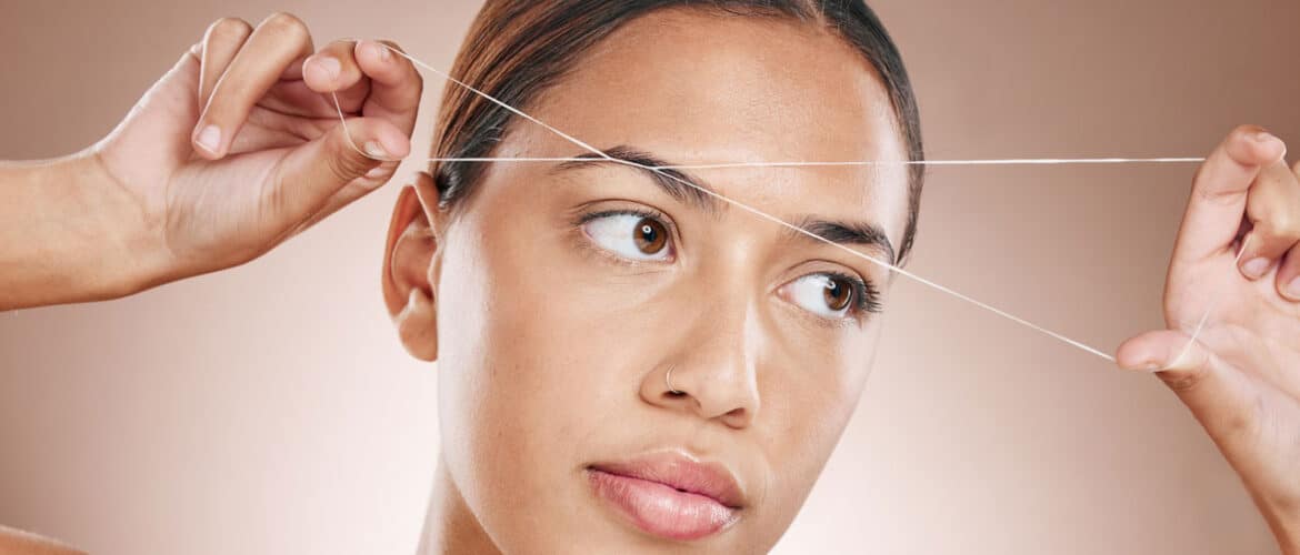 Eyebrow threading being performed with precision